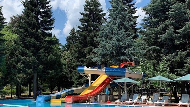 A swimming pool with multiple slides and lounge chairs. - Gloria Saints Constantine And Helena (Varna)