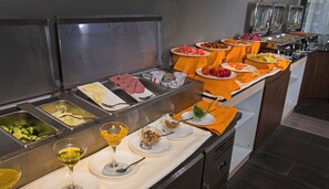 A buffet with various food items and drinks. - Mado Hotel (Addis Ababa)