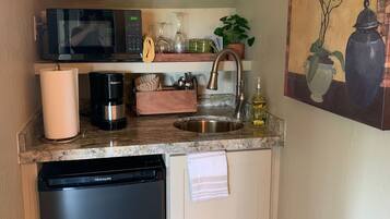 Fridge, microwave, coffee/tea maker, cookware/dishes/utensils