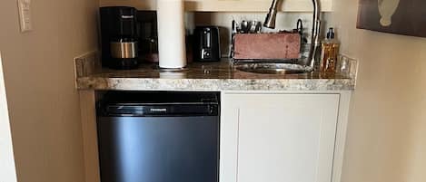 Fridge, microwave, coffee/tea maker, cookware/dishes/utensils