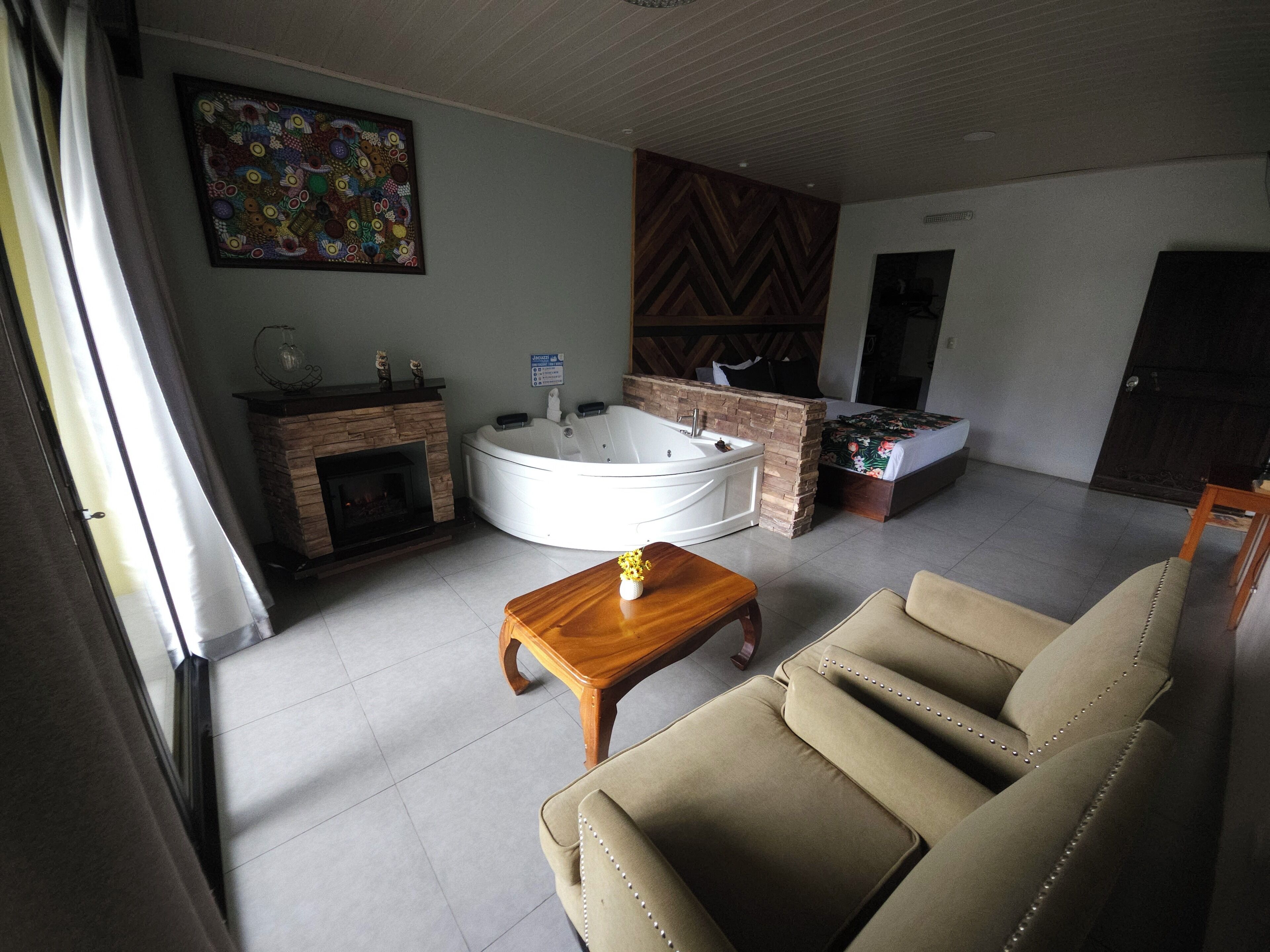 Deluxe Suite, Hot Tub, Hill View | Living area | 40-inch flat-screen TV with satellite channels, TV, fireplace