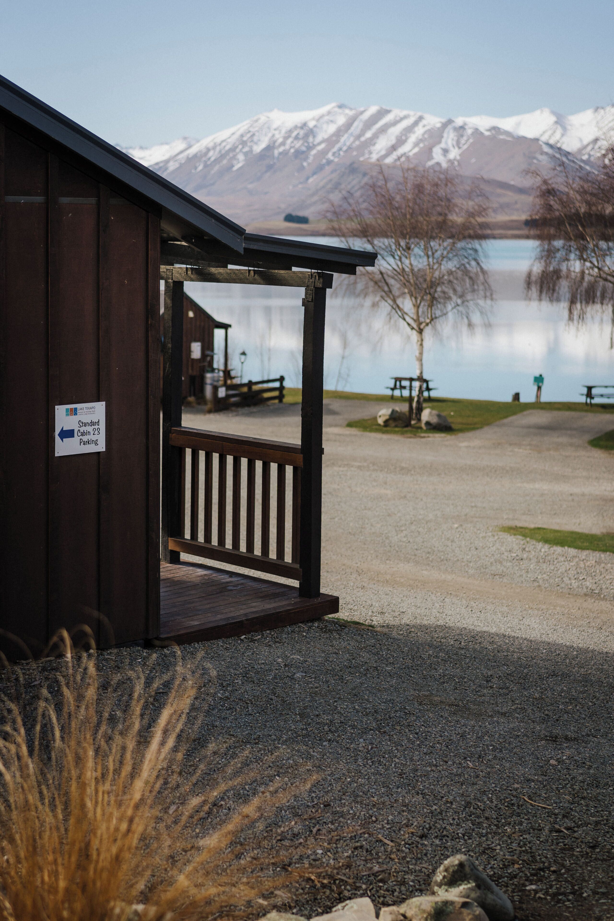 A wooden building with a sign indicating 'Standard Cabin 23 Parking.'