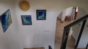 A staircase with a handrail, a hat on the wall, and three framed paintings. - Lovely Villa with gorgeous views - Sleeps 6 (Heated Pool) (L'Atzúbia)