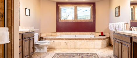 A bathroom with a bathtub, toilet, and sink.
