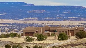A building with a flat roof and a simple, rectangular structure. - Secluded Desert Oasis: Luxurious Inn-Abiquiu Lake Views-Daily Gourmet Breakfast. (Abiquiu)