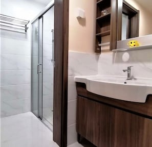 Shower, hair dryer, slippers, towels