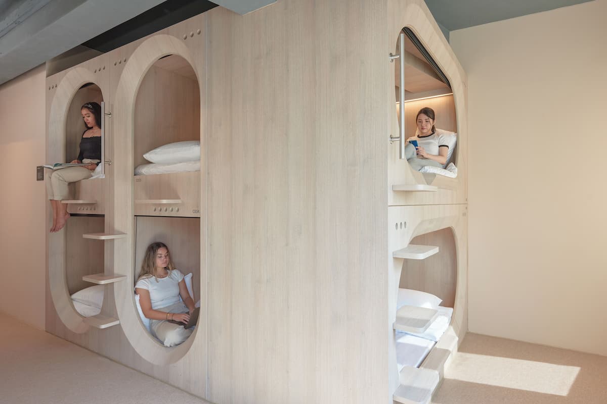 A modern interior with circular alcoves and built-in shelves.
