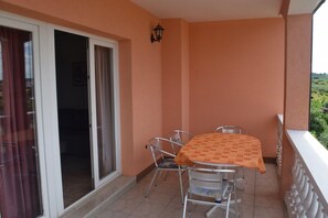 Enjoy a quiet moment on the balcony with a table and chairs, perfect for taking in the views.