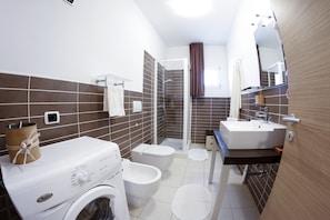 Shower, hair dryer, towels, toilet paper