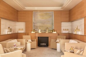 A luxurious lounge area with plush seating, a fireplace, and a large abstract painting on the wall. - The Woodward An Oetker Collection Hotel (Geneva)