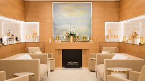 A luxurious room with a fireplace, seating area, and a large painting above it. - The Woodward An Oetker Collection Hotel (Geneva)
