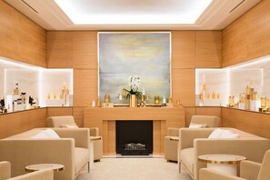 A luxurious room with a fireplace, seating area, and a large painting above it. - The Woodward An Oetker Collection Hotel (Geneva)