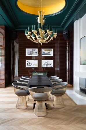 A conference room with a long table, six chairs, and a chandelier. - The Woodward An Oetker Collection Hotel (Geneva)