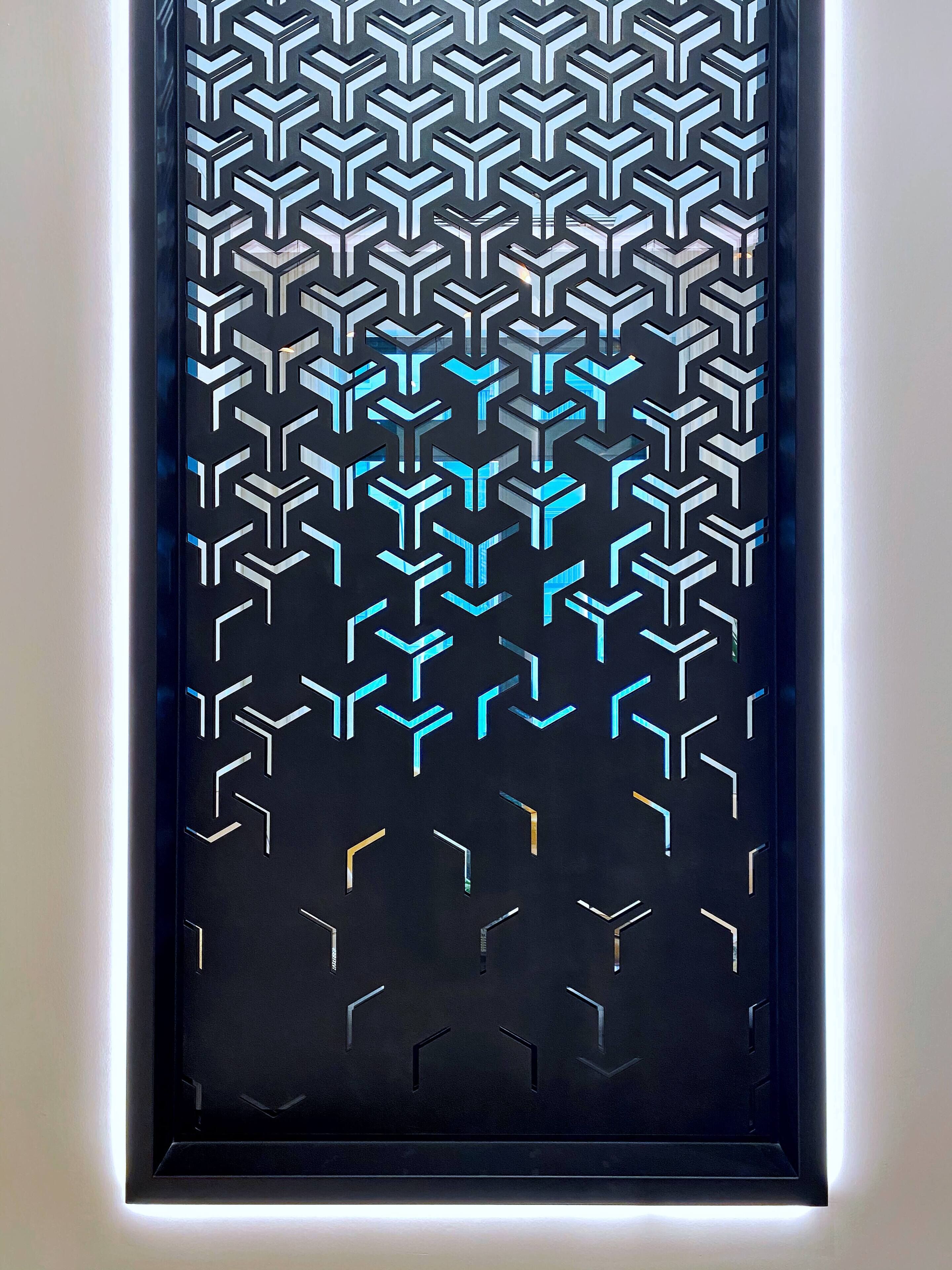 A door with a geometric pattern and a light strip along the bottom.