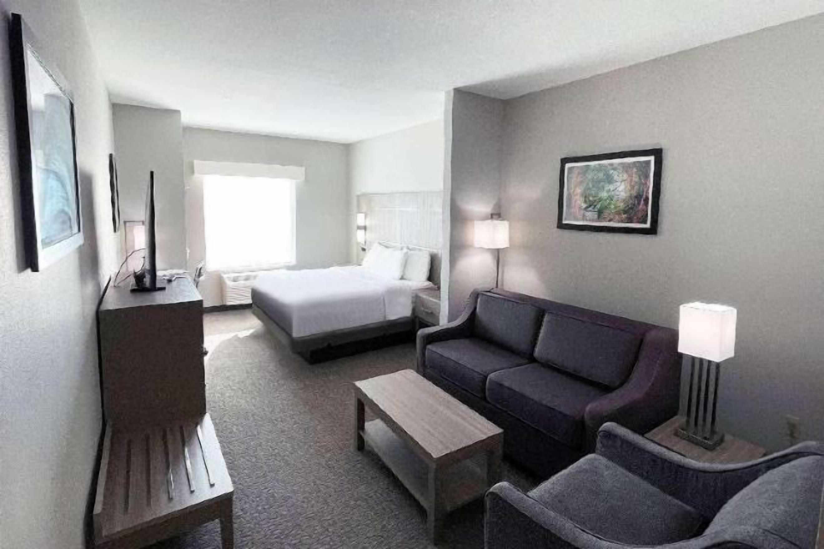 Hypo-allergenic bedding, desk, laptop workspace, blackout drapes