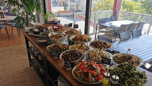 A buffet with various dishes and drinks.