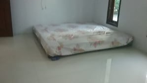 A room with a mattress on the floor, a window, and a door. - Dwi Sigit Homestay (Imogiri)