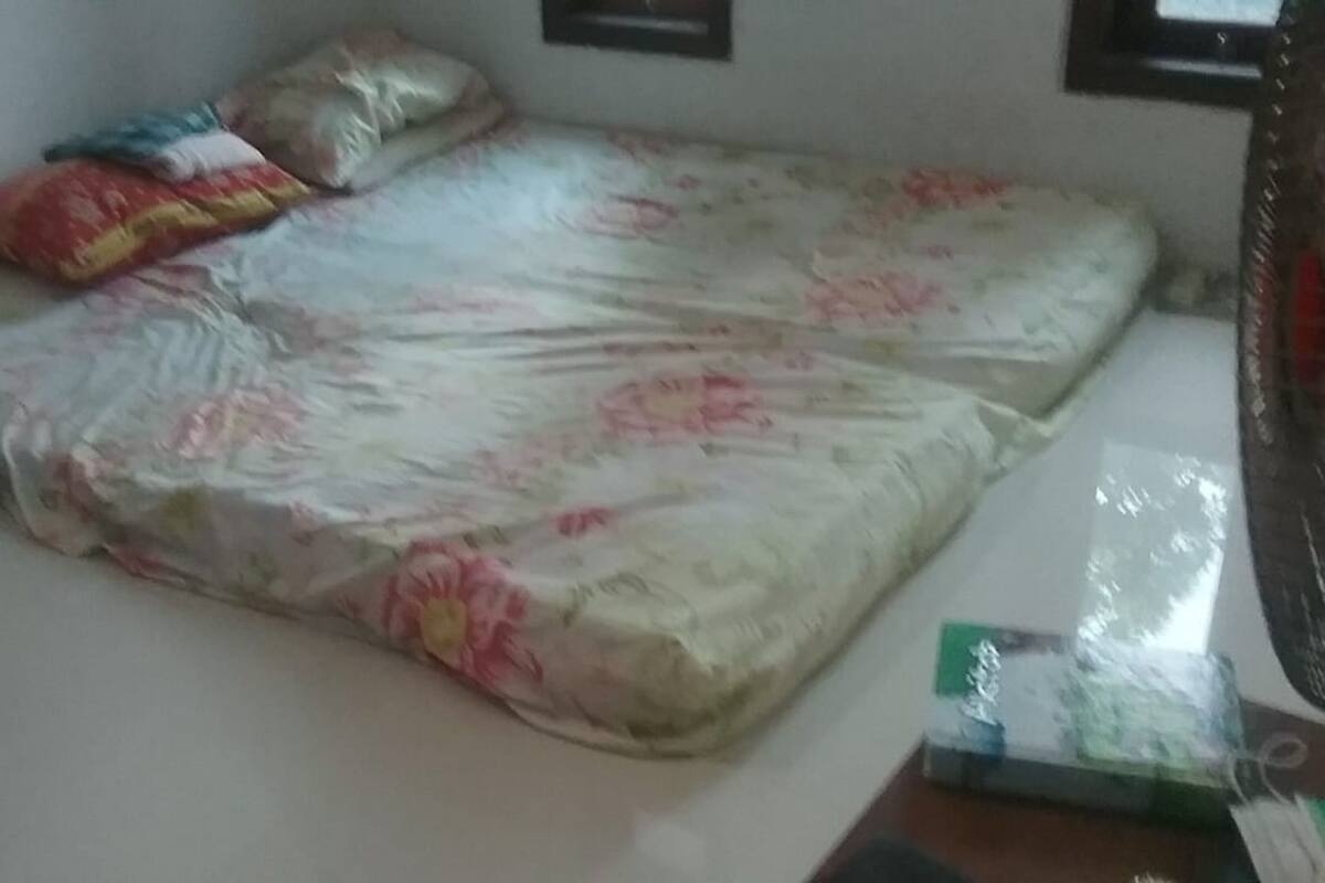 Laptop workspace, bed sheets