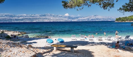 On the beach, white sand, beach umbrellas, beach bar
