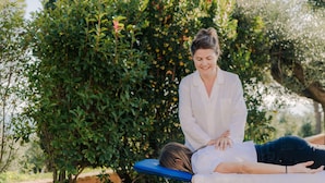 A person lying on a blue examination table outdoors with a professional standing beside them. - Rent room Nontiscordardimè (Civitanova Marche)
