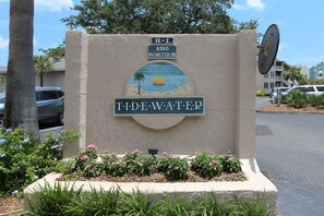 A sign for 'Tidewater' with a beach scene, located at 8500 Palmetto Dr.