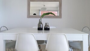 A white dining table with two vases and a potted plant. - Tranquility and peace, in Maires la Isla (Mar del Plata)