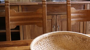 A kitchen with wooden cabinets, a tiled backsplash, and a woven basket on the table. - a-domo Apartments Oberhausen - Budget Apartments & Flats - short & longterm - single & grouptravel (Oberhausen)