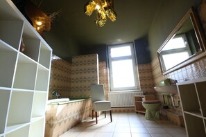A bathroom with a tiled floor, a chair, a sink, a toilet, and a window. - a-domo Apartments Oberhausen - Budget Apartments & Flats - short & longterm - single & grouptravel (Oberhausen)