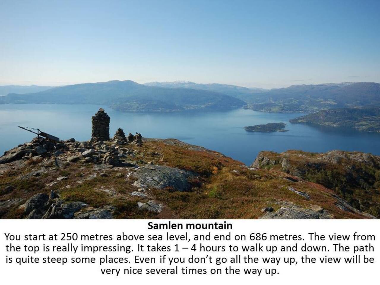 A mountainous landscape with a clear view of a lake and distant mountains.