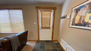 A hallway with a door, a radiator, and a framed picture on the wall. - Quiet location in "Swiss community" near Park City (midway)