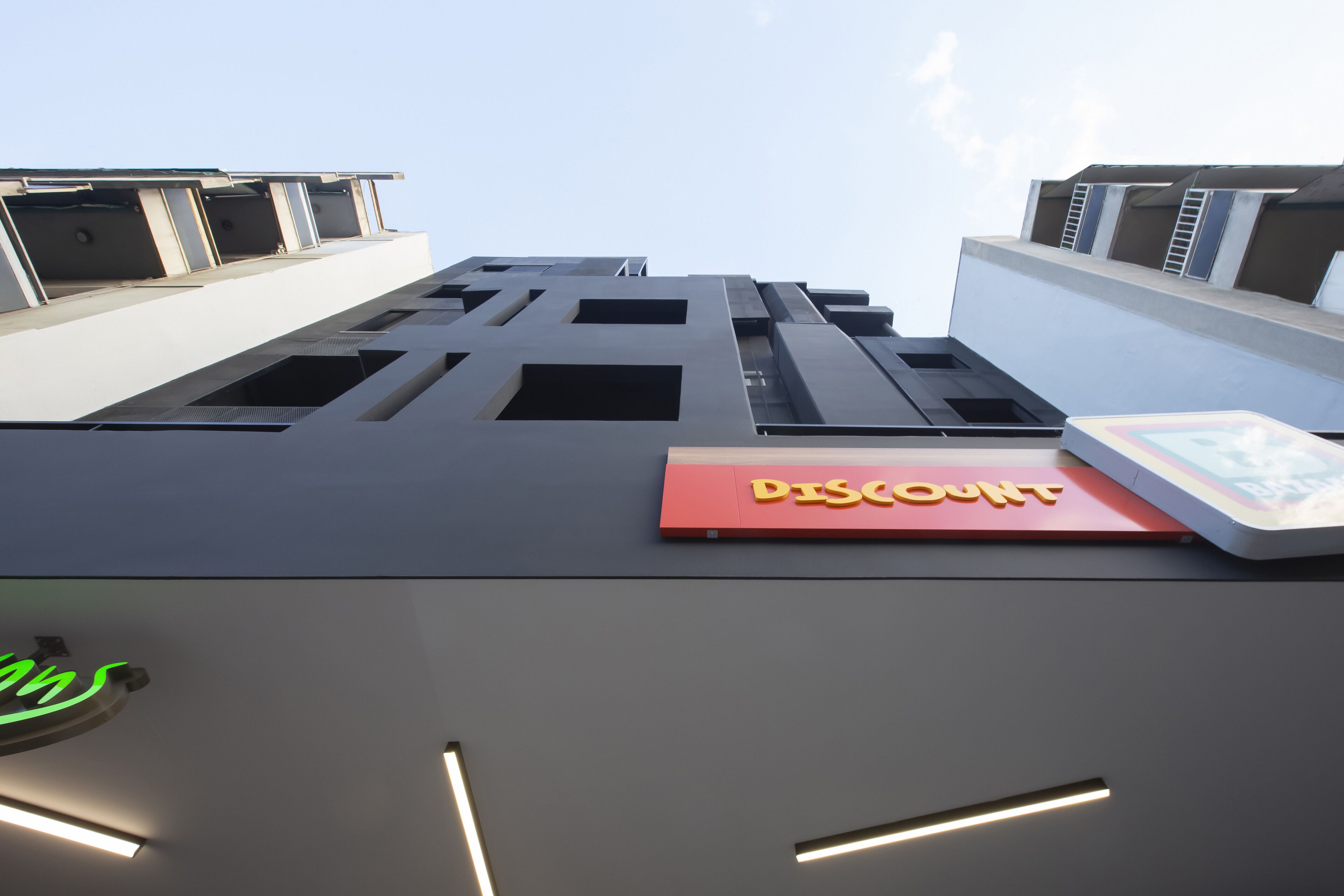 A modern building with a prominent 'Discount' sign on the facade.