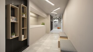 A modern hallway with built-in wooden shelving, a reception desk, and a bench. - Thisean Modern Suites by Athens Stay (Kallithea)