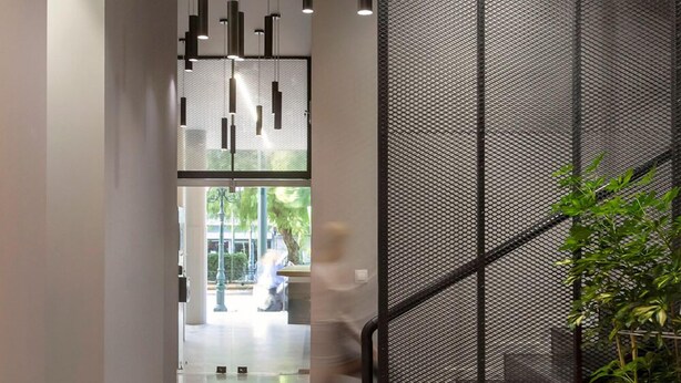 A modern interior with a staircase, a potted plant, and hanging pendant lights. - Thisean Modern Suites by Athens Stay (Kallithea)