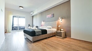 A modern bedroom with a large bed, bedside tables, and a view of the outside. - Thisean Modern Suites by Athens Stay (Kallithea)