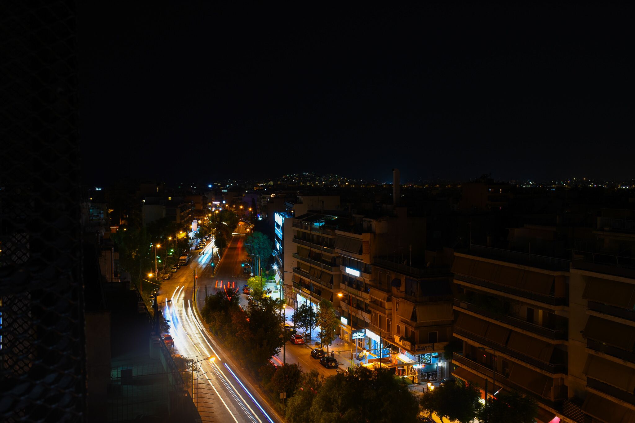 A nighttime cityscape with illuminated streets and buildings.