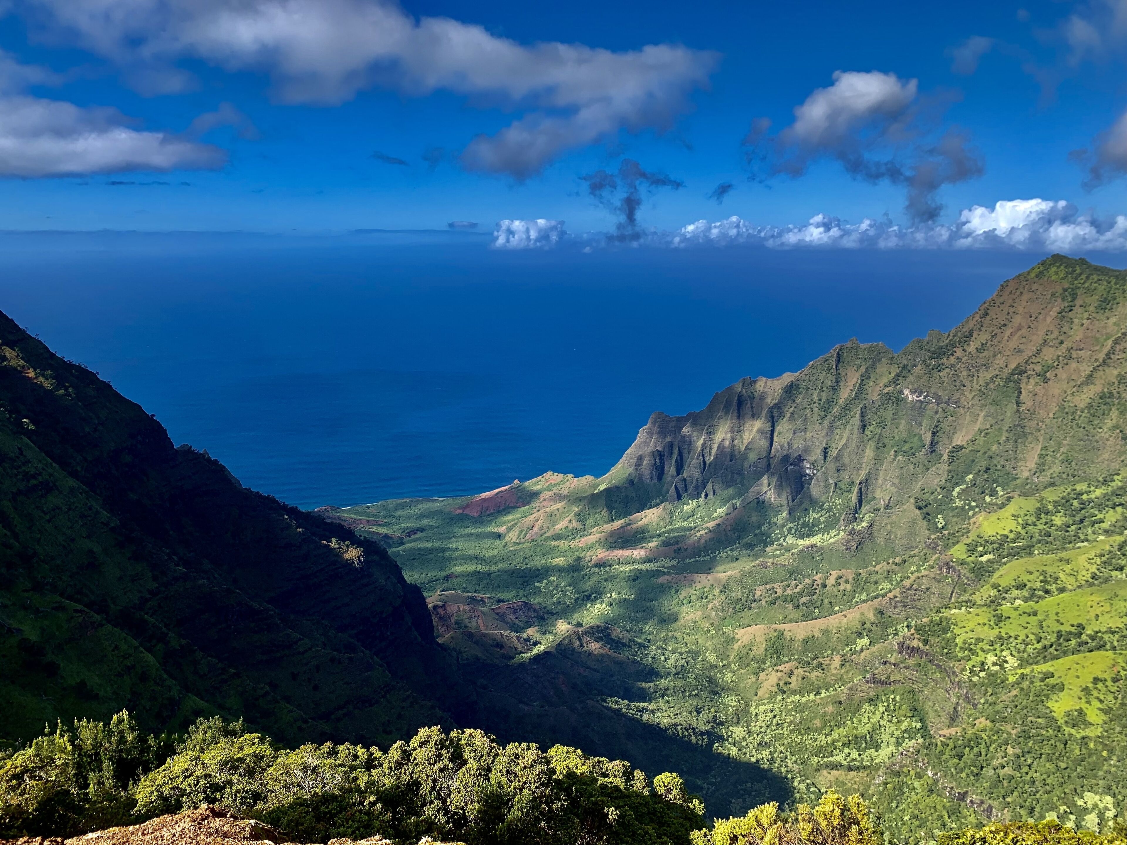 A mountainous landscape with a view of the ocean.