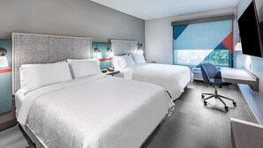 A hotel room with two beds, a desk, a chair, and a television. - avid hotel Bentonville – Rogers by IHG (Bentonville)