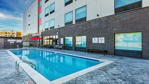 A swimming pool area with a pool lift, a bench, and a sign indicating no swimming. - avid hotel Bentonville – Rogers by IHG (Bentonville)