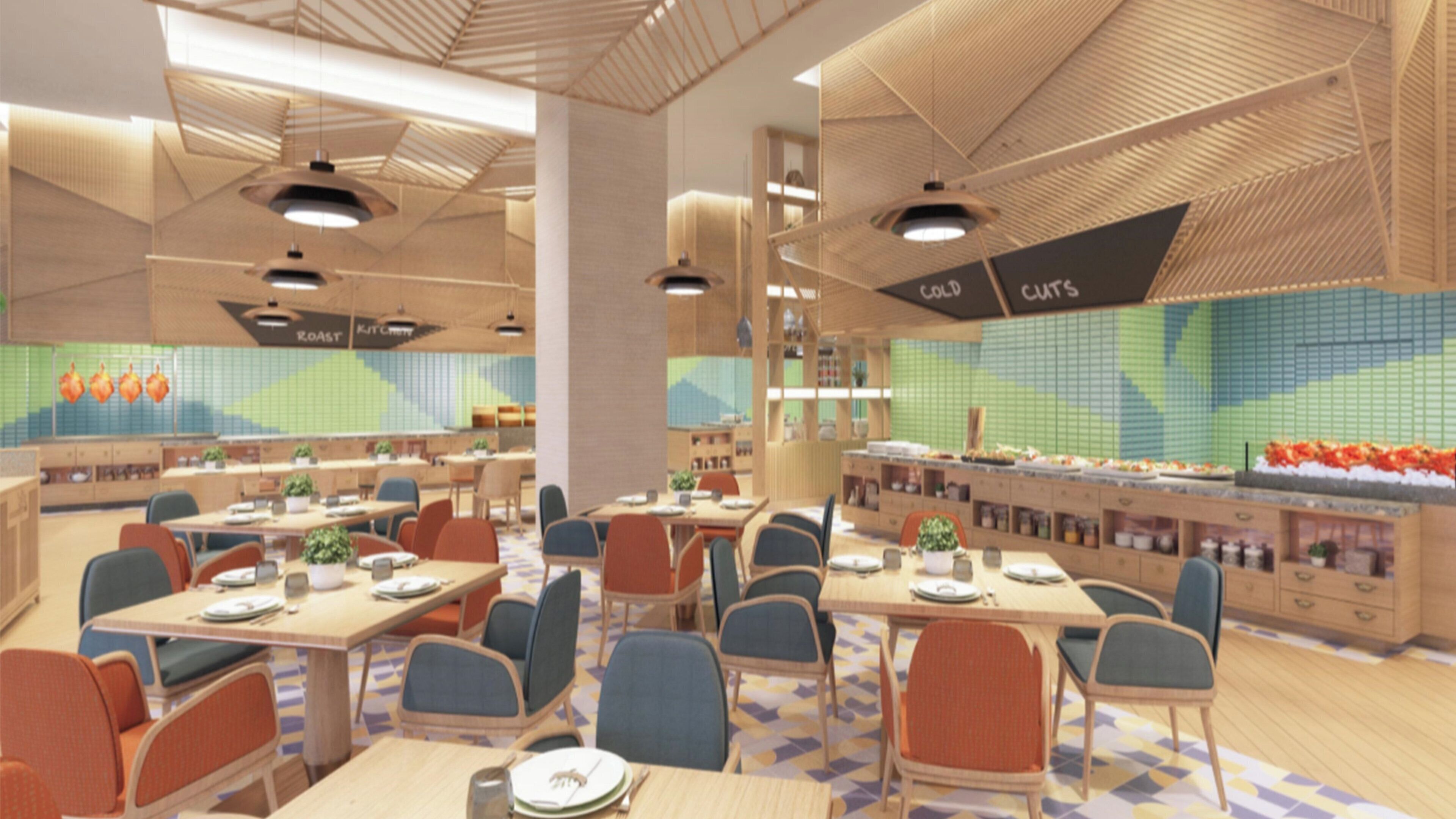 A modern restaurant with multiple dining tables, chairs, and a counter with food displays.