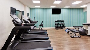 A gym with treadmills, dumbbells, and exercise balls. - Holiday Inn Express & Suites Fayetteville by IHG (Fayetteville)