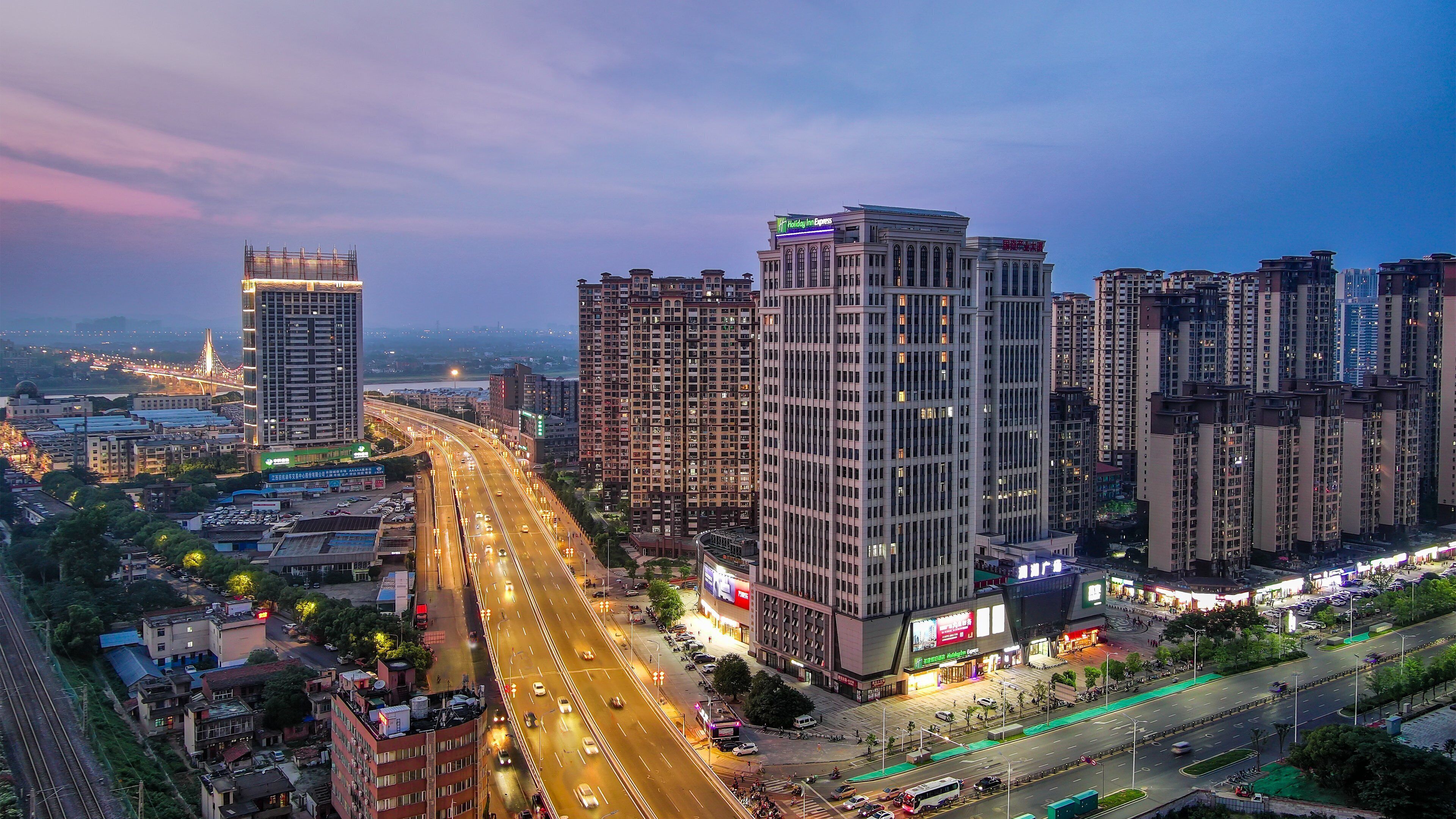 A high-rise hotel with multiple floors, a prominent entrance, and a view of the surrounding cityscape.