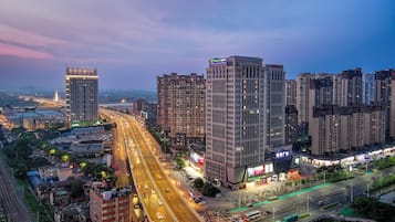 A high-rise hotel with multiple floors, a prominent entrance, and a view of the surrounding cityscape.