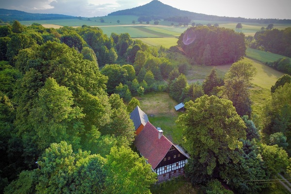 House and barn in the foothill of the Ostryca (Spitzberg) volcano 501m