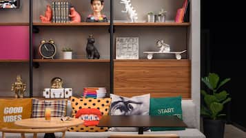 A modern living room with a sofa, a coffee table, and a bookshelf.