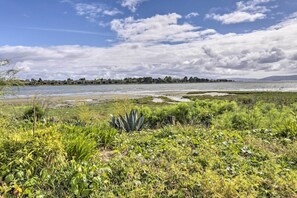 Surrounded by lush vegetation and a serene body of water.