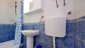 A bathroom with a bathtub, a sink, and a toilet.
