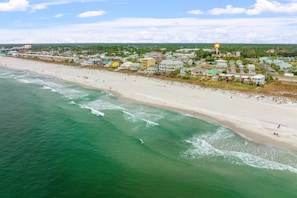 A coastal town with a sandy beach and ocean.