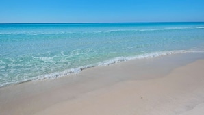A beach with clear blue water and a sandy shore. - Shores of Panama by iTrip Panama City Beach (Panama City Beach)
