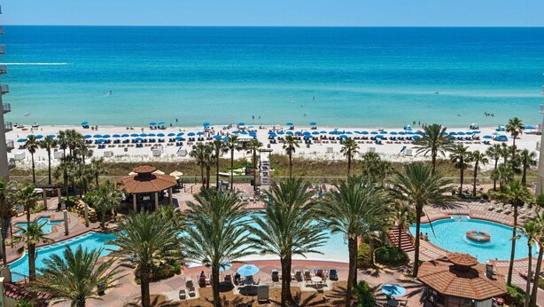 A resort with a pool area, beach, and ocean view. - Shores of Panama by iTrip Panama City Beach (Panama City Beach)