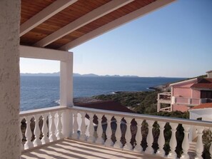 Enjoy breathtaking views of the sea and distant mountains from this balcony.